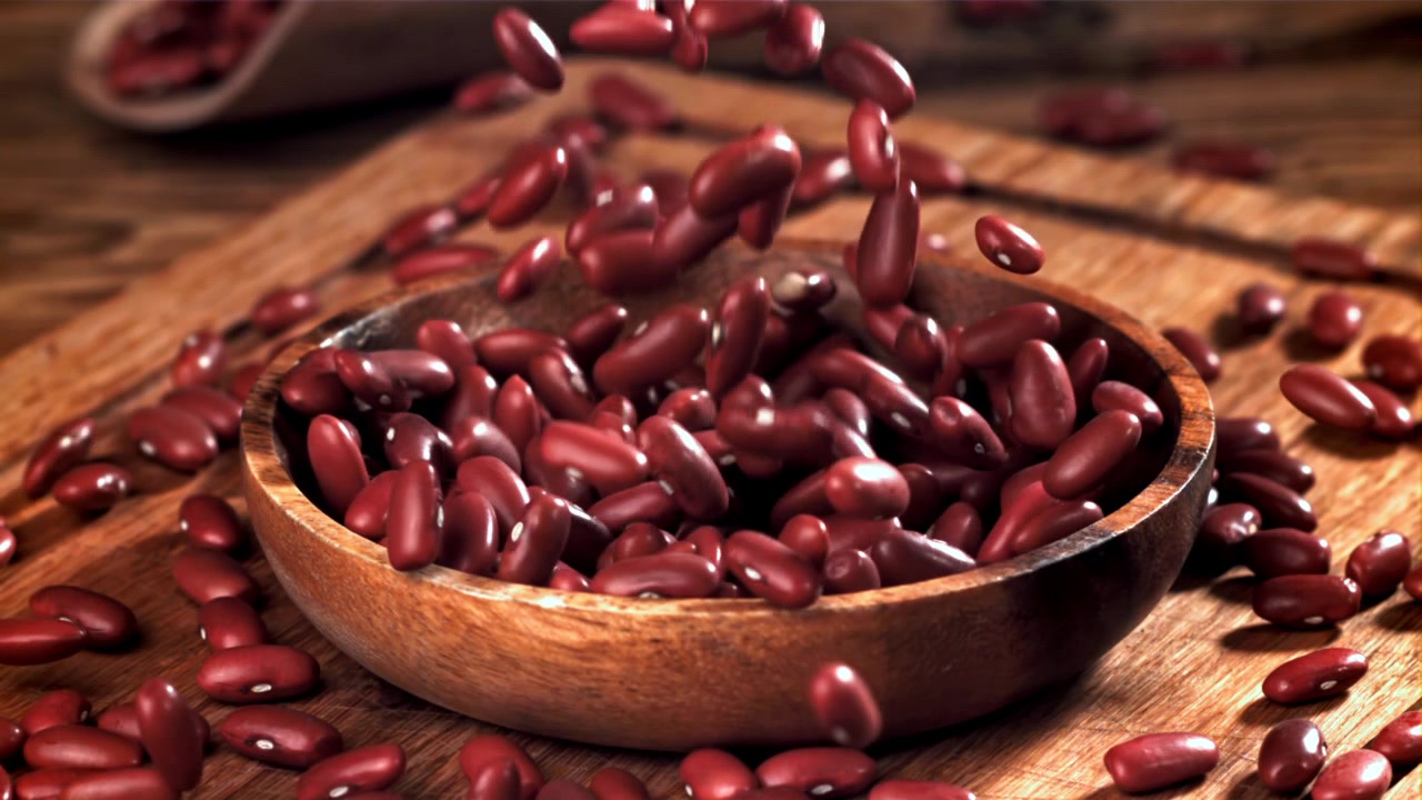 Slow Motion Red Kidney Beans Falling into Wooden Bowl
