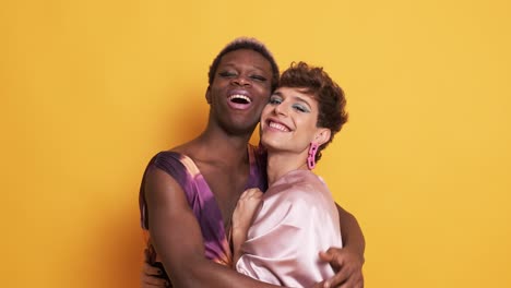 stylish trans men in make up and fashion clothes embracing and smiling