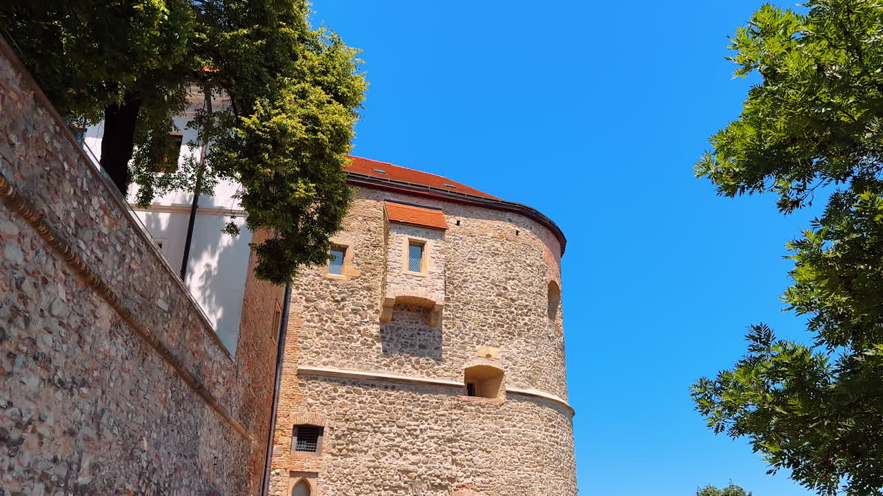 Tall brown brick walls of the old castle. Bratislava Castle from low angle perspective