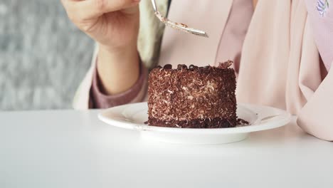 woman eating a chocolate cake