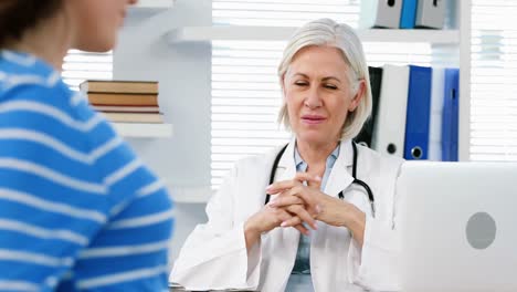 female doctor interacting with a pregnant woman