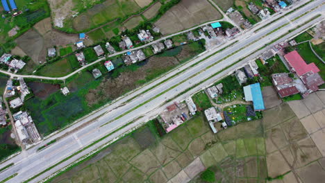 Diagonal-View-Of-Siddhartha-Highway-With-Vehicles-Driving-At-Daytime-In-Bhairahawa,-Nepal