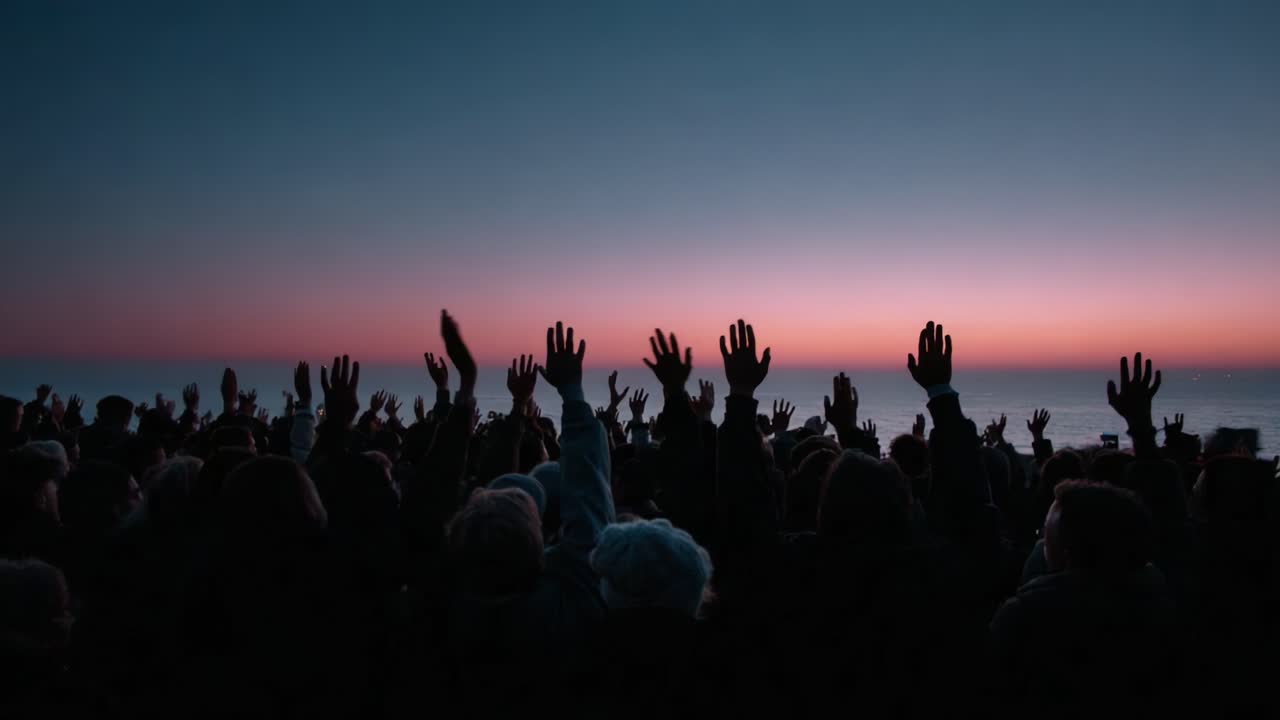 A Vibrant Sunset Gathering by the Water, Silhouettes of Enthusiastic People Raising Their Hands Against a Beautiful Gradient Sky