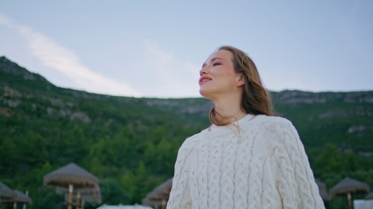 Relaxed woman looking coastal nature standing on beach closeup. Happy traveler