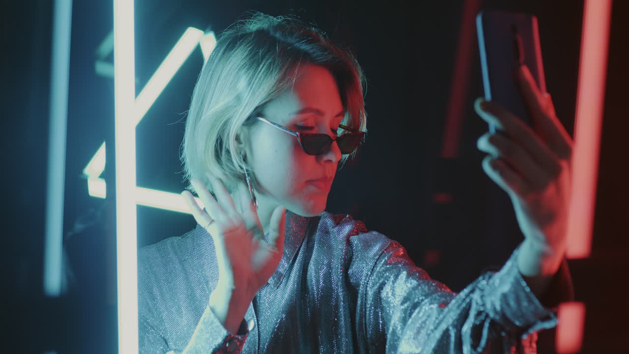 Woman Taking a Selfie in Neon Lights