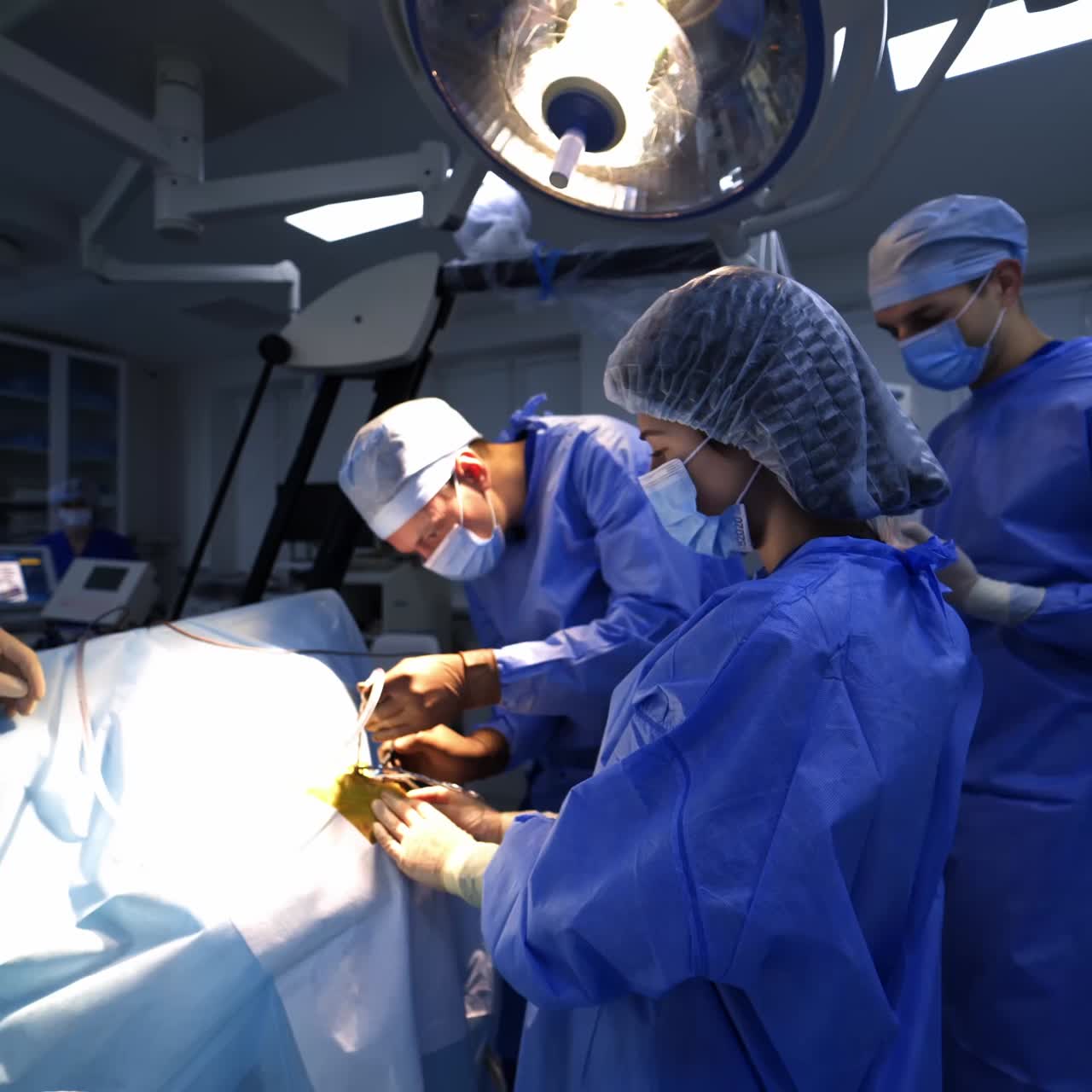 Medical team working in the operation room. Neurosurgeons surrounded by the modern medical equipment for operations. Big team working on a patient