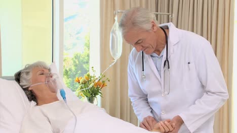 doctor visiting his patient under breathing assistance