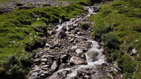 clear spring water through rocky landscape of kaprun, austria -aerial ascend