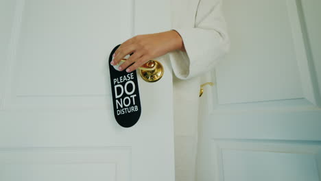 a woman refuses to clean the room hangs a do not disturb sign on the door