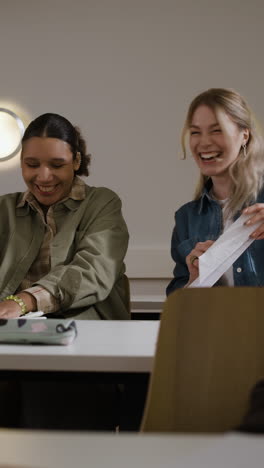 two women laughing in a classroom