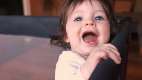 close-up of baby girl in baby cot