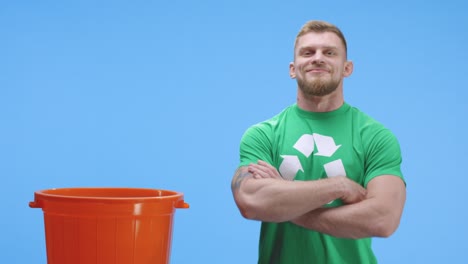 hombre eco-consciente poniendo botella en el cubo