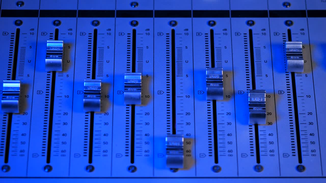 Professional Recording Studio. Interface of sound equipment for mixing music. Fader. Different modes of audio console. Process of working on song or voice. Neon blue light. 4k