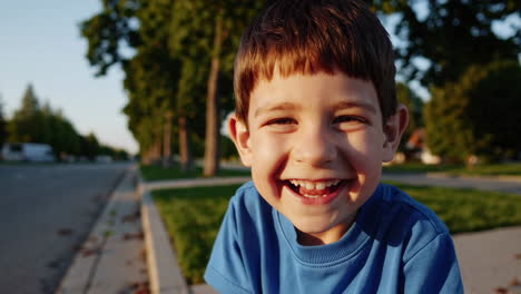happy young boy laughing outdoors