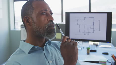 Thoughtful-businessman-in-modern-office