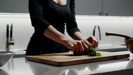 woman chopping greens in modern kitchen