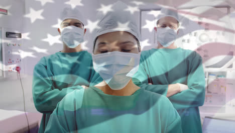 animation of flag of united states of america waving over surgeons in operating theatre