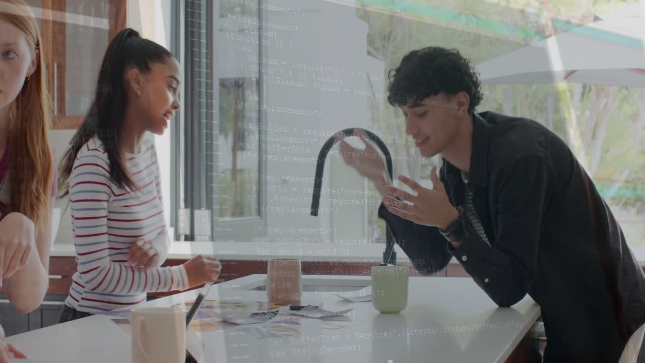 Three women leaning over kitchen island studying cards, fourth sorting, leading man joining design