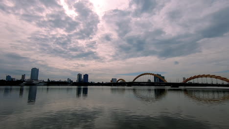 standing and looking at the bridge in da nang (vietnam).