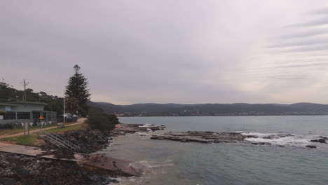 exiting lorne pier, australia lorn coast line. moving right to left, day time cloudy sky