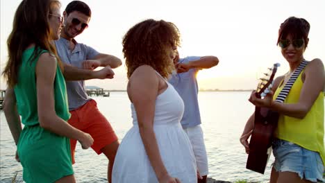 multi ethnic men and women enjoying beach party