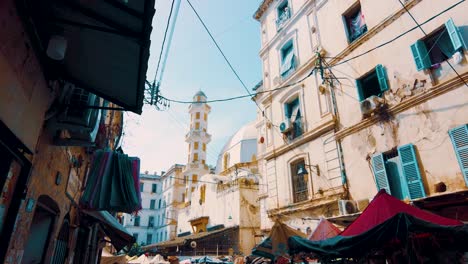 an alley in the popular district of bab el oued in algiers which overlooks an old mosque in the background