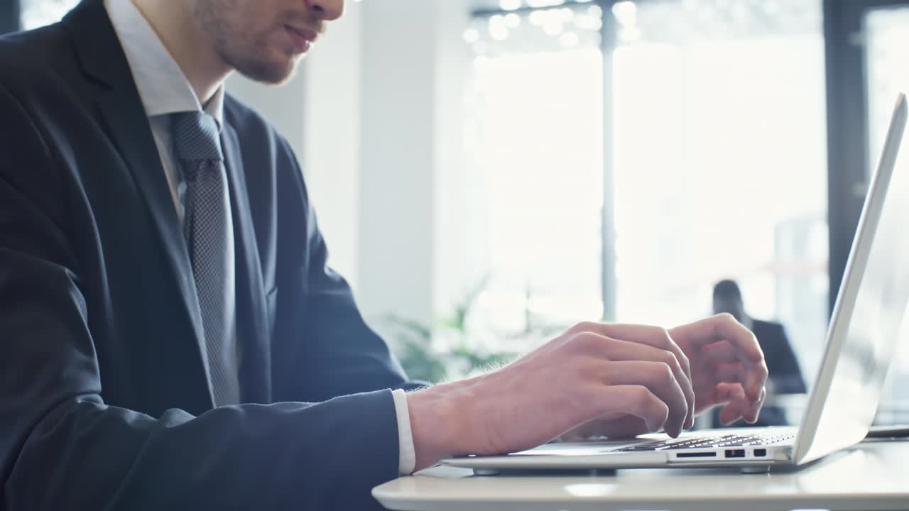 Young Man Working on Laptop in Business Center