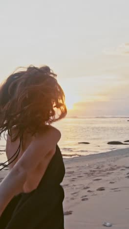 young caucasian woman holds boyfriend hand says follow me running along beach