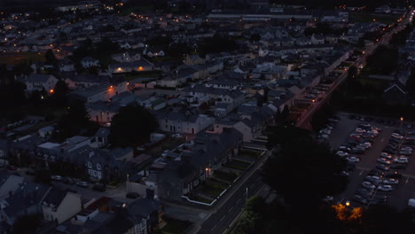 Fliegen-Sie-Nach-Sonnenuntergang-über-Die-Städtische-Nachbarschaft.-Wohngebäude-Entlang-Der-Geraden-Straße.-Killarney,-Irland