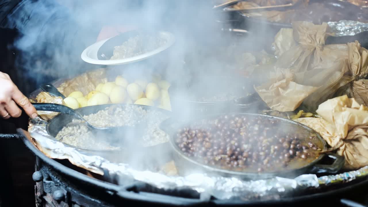 Steaming traditional Latvian meal of peas with bacon and sausage at market stall