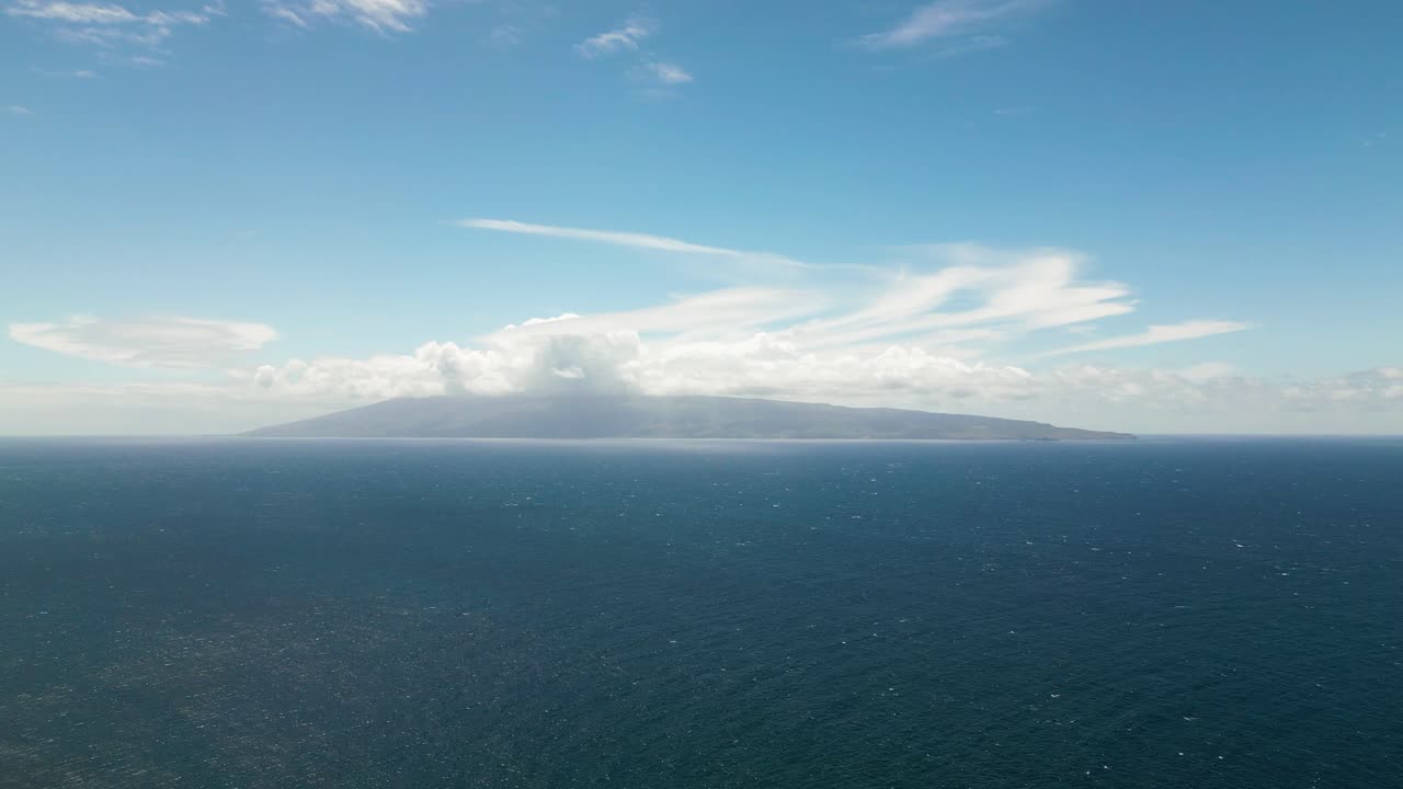 Distant Island in a Vast Ocean under a Blue Sky
