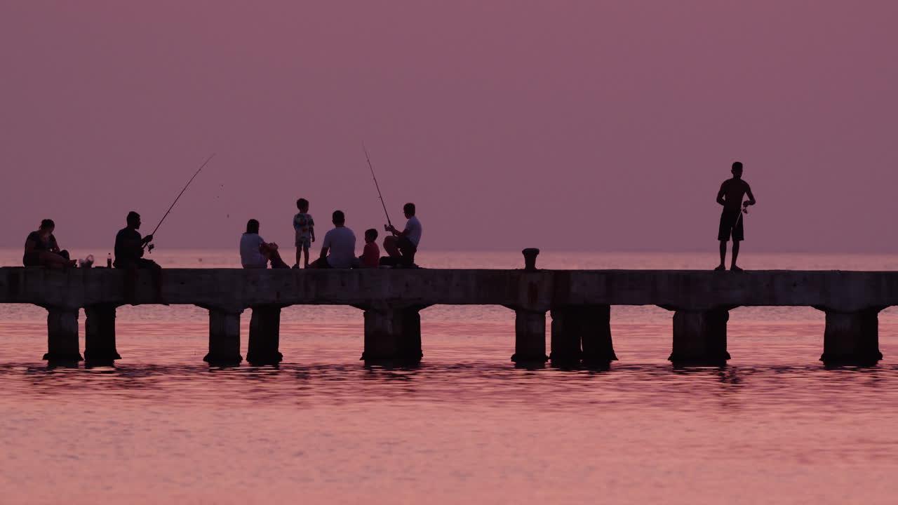 Serene sunset fishing on Greek pier
