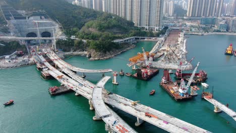 Hong-Kong-cross-bay-link-construction-project,-a-dual-two-lane-bridge-connecting-Tseung-Kwan-O-Lam-Tin-Tunnel-to-Wan-Po-Road,-Aerial-view