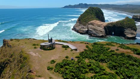 Aerial-drone-fly-above-time-dock,-muelle-del-tiempo,-landmark-at-chiloé-sea-shore,-hills-island-and-coastline-scene,-patagonia,-chile