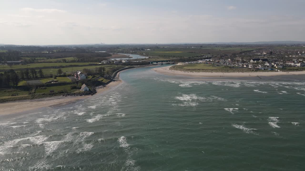 Drone shot of a small seaside town in Ireland on a sunny day