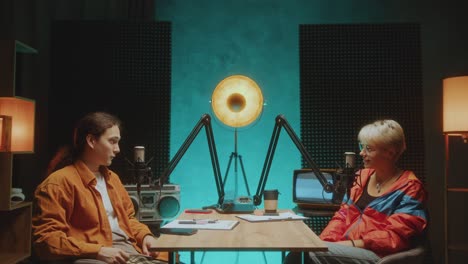 two social media influencers recording podcast together in audio studio