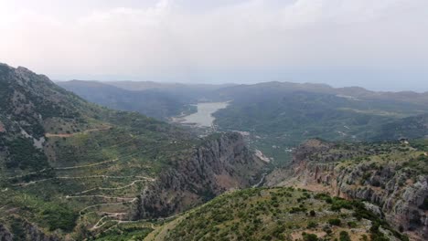 Drone-shot-aerial-view-of-the-mountain-road-and-valleys-at-Island-Spinalonga,-Crete,-Greece