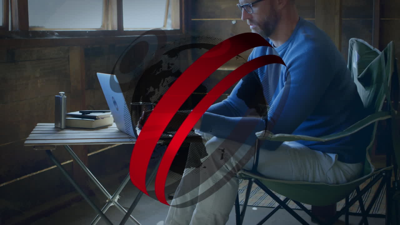 animación del globo y los círculos sobre el hombre caucásico usando una computadora portátil.