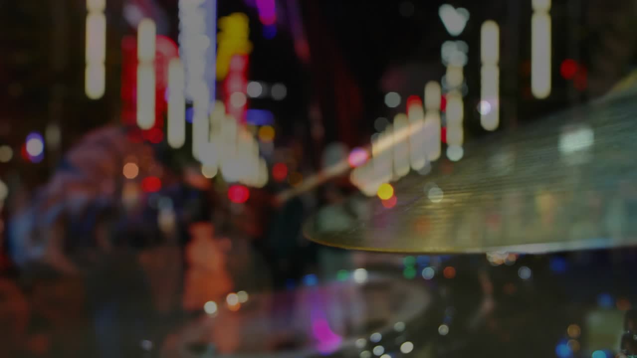 Male drummer entering frame, striking cymbal with stick, making music, neon streaks, drawing crowd