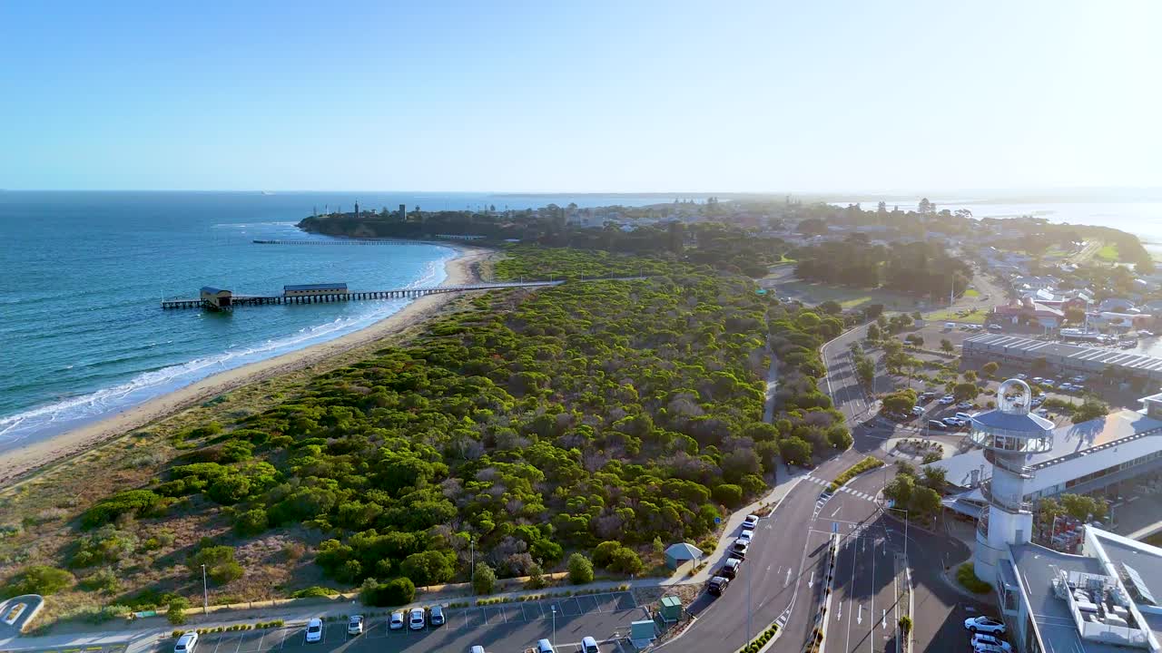 Drone footage captures the scenic coastline and lush greenery of Bellarine Peninsula, Victoria, under clear skies and bright sunlight