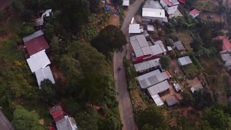 motorcycles riding through tin city in guatemala top down view aerial