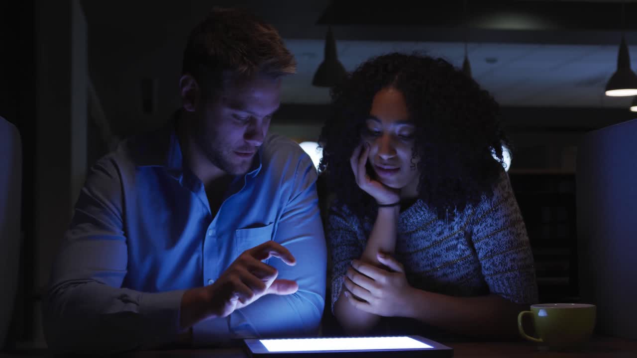 Young office executives working over digital tablet in a modern office