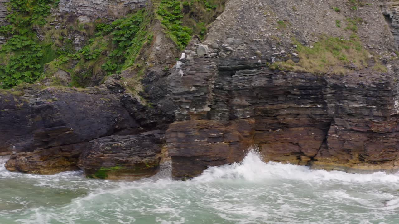 Reddish hue tint on basalt rock layers up to sedimentary geology of achill island ireland