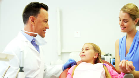 Dentist-interacting-with-young-patient