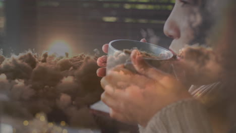 animation of biracial woman drinking tea over clouds