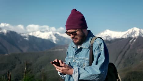 hipster male traveler planning touristic route electronic map smartphone application snowy mountain