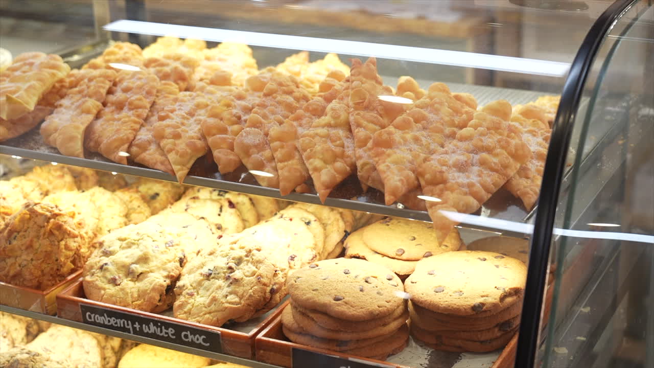 Cookies and cakes on display in a bakery, Australia