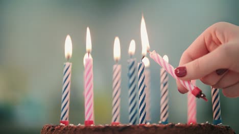 woman hand put candle flame in birthday cake. burning candle in birthday pie