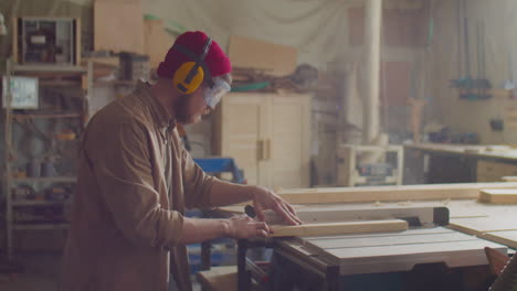 woodworker using power jointer machine