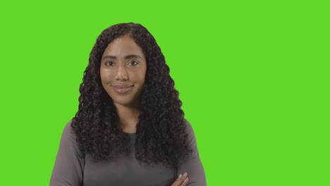 portrait of woman against green screen smiling at camera 2